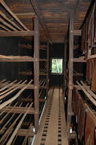 Racks of smoking room for rubber sheets hung on bamboo poles (2007)