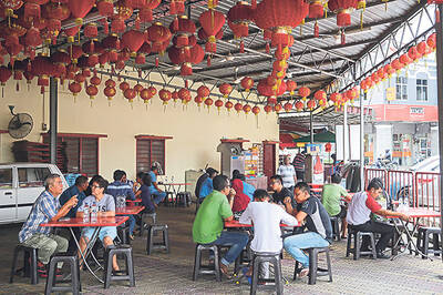 Diners sit under a canopy of red latterns to enjoy their fried noodles and cool treats. — Pictures by Choo Choy May